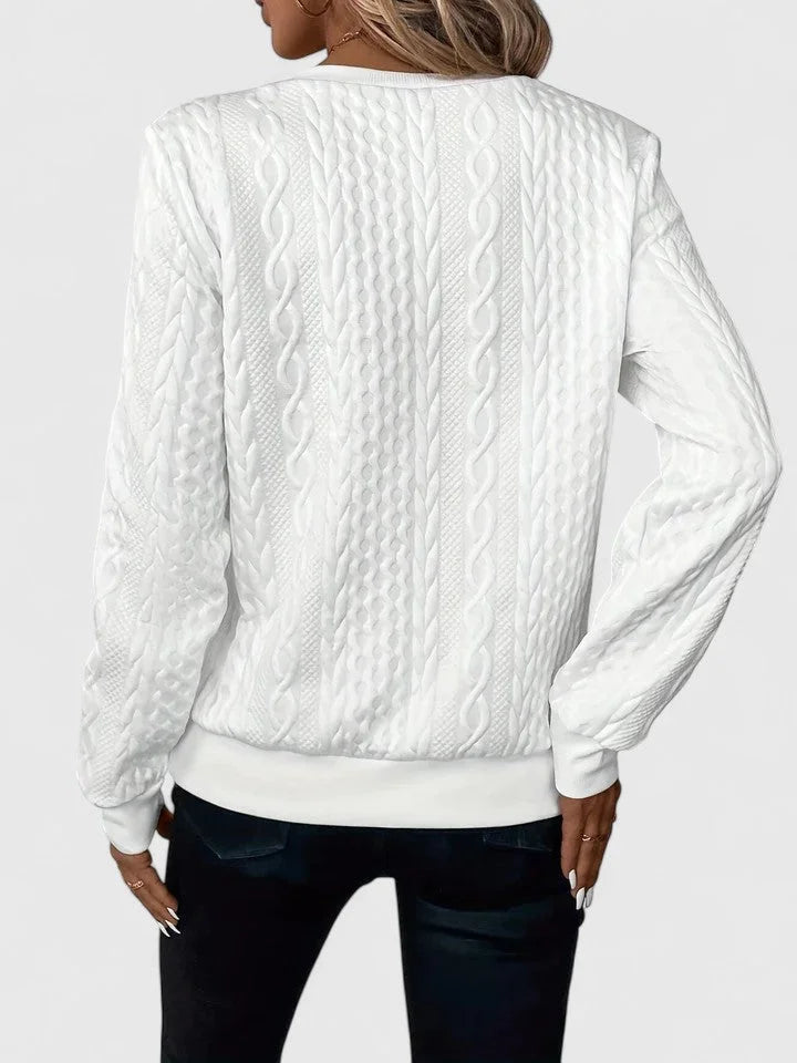 Women's cable-knit sweater with half-zip front and long sleeves